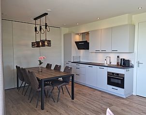 Eetkamer in Vakantiehuis Texel, De Cocksdorp, met een ruime tafel en eigentijdse verlichting.