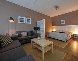 Stijlvolle woonkamer van Type 3 - 2103 vakantiehuis, De Cocksdorp, Texel, met gezellige zitgelegenheid en decoratieve kunst.