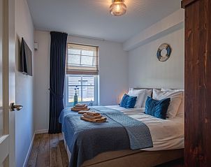 Comfortabele slaapkamer in Appartement B, vakantiehuis in De Cocksdorp, Texel, met luxe beddengoed.