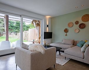 Cozy living room of Holiday home Brakzand in De Cocksdorp, Texel, overlooking the garden and modern furnishings.