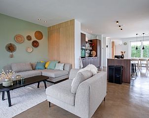 Open living space in Holiday home Brakzand, De Cocksdorp, Texel, with modern kitchen and cozy sitting area for a relaxing stay.