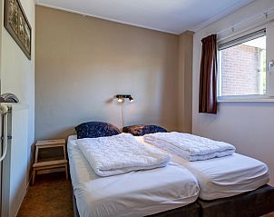 Cozy bedroom in Holiday home Slufterhoek 132, De Cocksdorp, Texel with comfortable double bed and natural light.