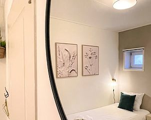 Knusse slaapkamer in Vakantiehuis in De Cocksdorp, Texel met natuurlijke accenten.