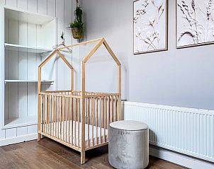 Kinderhoek in Vakantiehuis in De Cocksdorp, Texel met houten ledikant.