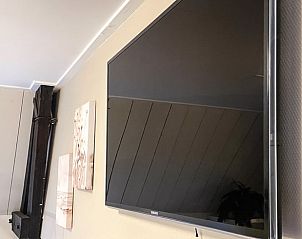 Moderne voorzieningen in Vakantiehuis in De Cocksdorp, Texel met flatscreen tv.