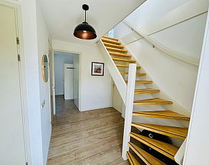 Heldere hal met trap in Texels Vakantiehuis, De Cocksdorp, een warm welkom op Texel, Waddeneilanden.