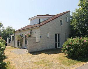 Vacation home D 740 in De Cocksdorp, Texel offers a charming exterior with green surroundings on the Wadden Islands.