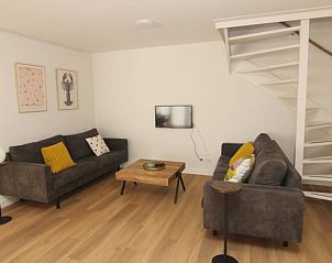 Cozy living room in Holiday home D 449, De Cocksdorp, Texel with modern furnishings and comfortable sofas, ideal for relaxation.