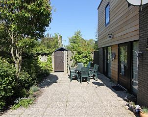 Enjoy the sunny garden of Holiday home A 167 in De Cocksdorp, Texel, with a spacious terrace surrounded by greenery on the Wadden Islands.