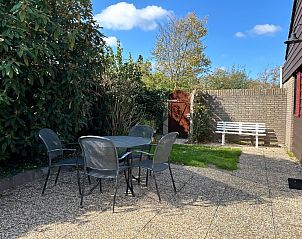 Enjoy the sunny garden at Holiday home B 163 in De Cocksdorp, Texel. Relax on the terrace amidst the serene nature of the Wadden Islands.