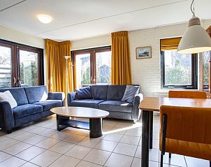 Cozy living room of Holiday home B 195 in De Cocksdorp, Texel with comfortable sofas and lots of natural light.