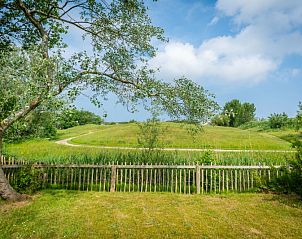 Rustgevend uitzicht vanaf Vakantiehuis D 473 in De Cocksdorp, Texel, omringd door groene natuur en een schilderachtig landschap.