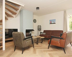 Cozy living room of Holiday home D640 in De Cocksdorp, Texel, with comfortable sitting area and modern fireplace.