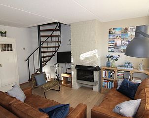 Gezellige woonkamer van Vakantiehuis D 696 in De Cocksdorp, Texel met comfortabele zithoek en sfeervolle open haard.