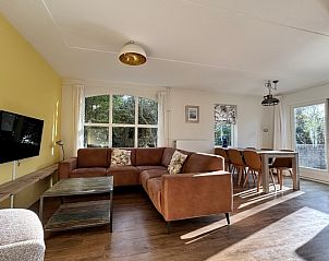 Cozy living room of Holiday home D 633 in De Cocksdorp, Texel, Wadden Islands with comfortable sofas and lots of natural light.
