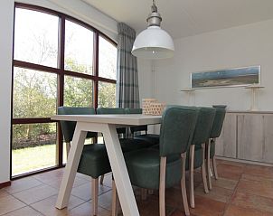 Cozy dining room in Holiday home E 645, De Cocksdorp, Texel with large windows and green view.
