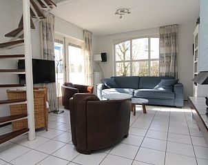 Cozy living room in Holiday home F 684, De Cocksdorp, Texel. Comfortable sitting area with lots of natural light and views of the garden.