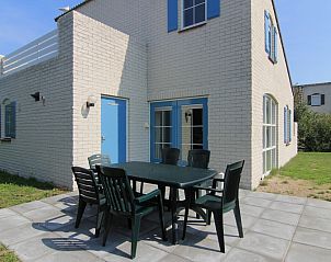 Relax on the sunny terrace of Holiday home F 675 in De Cocksdorp, Texel, a charming vacation home on the Wadden Islands.