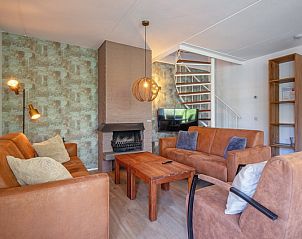 Knusse woonkamer in Villapark Residentie Texel nr. 719, vakantiehuis in De Cocksdorp met comfortabele zithoek en moderne open haard.