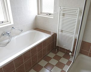 Ontspan in de moderne badkamer met ligbad in Bungalow 23, een vakantiehuis in De Koog, Texel.