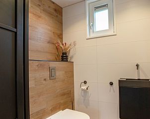 Moderne toiletruimte in De Houtsnip vakantiehuis, De Koog, Texel met houten accenten.