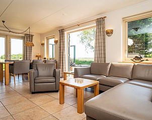 Spacious interior of Villa, De Koog, Texel with modern decor and views of nature.