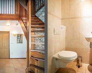 Entrance and toilet of Villa, De Koog, Texel with wooden staircase and modern finishes.