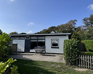 Bungalow 33 in De Koog, Texel biedt een rustige buitenruimte met terras en groene omgeving.