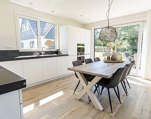 Lichte eetkamer in Villa 35a, vakantiehuis in De Koog Texel, met toegang tot het terras op de Waddeneilanden.