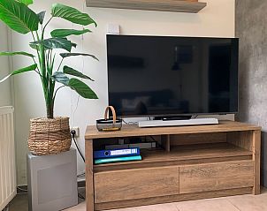 Unterhaltungsecke im Duo-Bungalow, De Koog, Texel mit groem Fernseher und Pflanzendekoration.