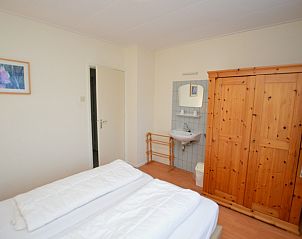 Epelaan 19 / Arjen vakantiehuis De Koog Texel slaapkamer met houten kast en wastafel.