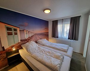 Comfortable bedroom in Chalet Bregkoog 103, Chaletpark Bregkoog, De Koog, Texel with large windows.