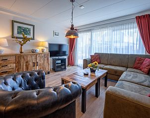 Lichte woonkamer in Appartementen Anna - de Zeehond, De Koog, Texel met grote ramen en gezellige zitmogelijkheden.