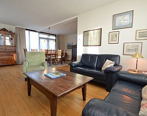 Open leefruimte in vakantiehuis Orchismient 35, De Koog, Texel, met houten vloeren.