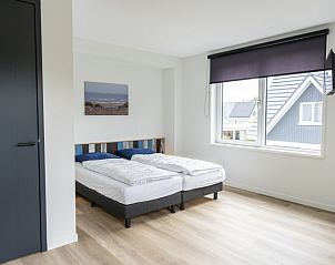 Lichte slaapkamer met tweepersoonsbed in Villa 37, vakantiehuis in De Koog, Texel.