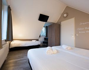 Gezellige slaapruimte in Villa 4, De Koog Texel, perfect voor een ontspannen verblijf op de Waddeneilanden.