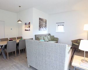 Gezellige binnenruimte van Kustpark huizen vakantiehuis in De Koog, Texel, met comfortabele zithoek en eetgedeelte.