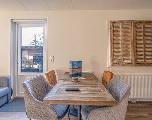 Eethoek met rustiek houten tafel in Appartement Zee van Tijd, De Koog, Texel, perfect voor gezellige maaltijden.