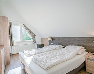 Gemtliches Schlafzimmer im Ferienhaus Honeysuckle 95, De Koog, Texel mit Blick auf die grne Umgebung.