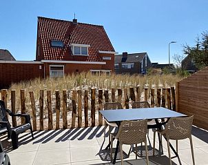Privterras van De Duinroos vakantiehuis, Texel met uitzicht op de rustige omgeving.