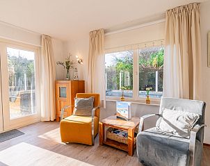 Seating area with garden view in Holiday home Honeysuckle 61, De Koog, Texel, Wadden Islands.