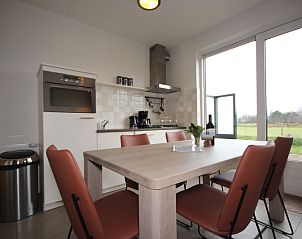 Cozy kitchen of Holiday Home in De Koog, Texel overlooking the nature of the Wadden Islands.