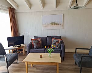 Ruime leefruimte in Motel Texel Appartement (Y), De Koog, Texel met zithoek en uitzicht op de natuur.