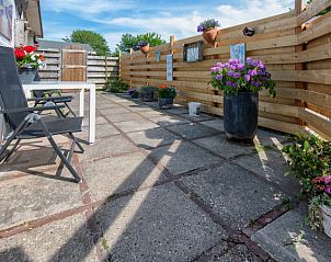 Zonnig terras van Vakantiehuis 2490 in De Koog, Texel, omgeven door houten schutting.