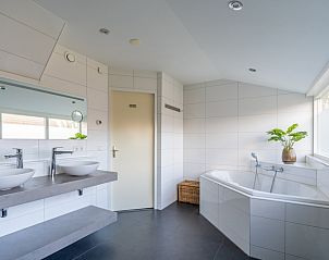 Stijlvolle badkamer in Vakantiehuis Kamperfoelie 43 met sauna, De Koog, Texel, met groot bad en moderne inrichting.