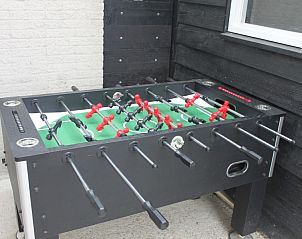 Gezellige woonkamer in Huize 100-1, vakantiehuis in De Koog, Texel, met comfortabele zitplaatsen.