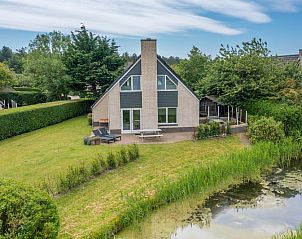 Uitzicht op Vakantiehuis Kamperfoelie 71 in De Koog, Texel, met groene omgeving.