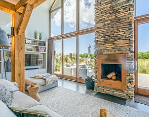 Villa 193, De Koog, Texel, woonkamer met grote ramen en uitzicht op het terras.