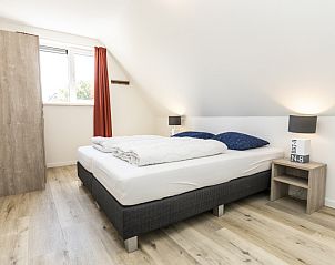 Gezellige slaapkamer in Villa 21, De Koog, Texel, met knusse inrichting en veel comfort.