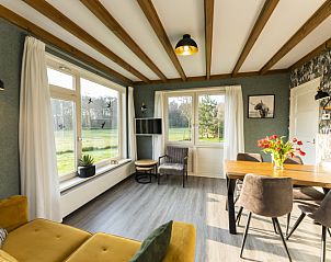 Lichte woonkamer van De Koperwiek in De Koog Texel met uitzicht op natuur.